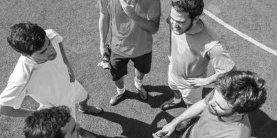 Soccer players talking between them in a soccer field – overhead
